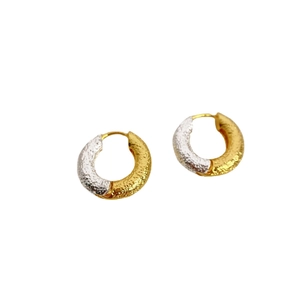 Modern two-tone gold and silver hoop earrings with a textured hammered finish for women