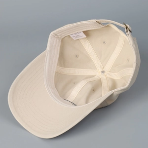Beige washed cotton baseball cap with adjustable strap and 100% cotton inner structure