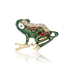 Green enamel frog brooch with sparkling crystals and gold accents on a white background