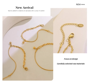 Detail of 18K gold plated double layer lip chain with steel bead charm and lobster clasp