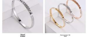 Detailed view of pyramid studs and pavé crystals on three-tone titanium steel bangles