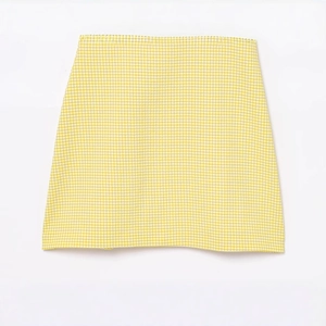 Short yellow plaid A-line dress with bow detail shown on a clean white background