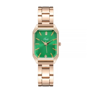 Close-up of rose gold rectangular watch with green dial and diamond accents at 12 and 6