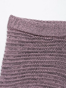 Close-up of lavender knit fabric showing elastic waist ribbing and crochet texture