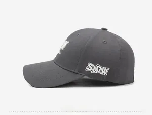 Detail showing white SLOW letter embroidery on side of dark grey baseball cap