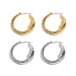 Detailed view of gold and silver moon face earrings with sparkling zircon crystals
