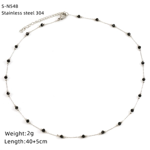 Flat lay of 304 stainless steel necklace with black beads on a white background