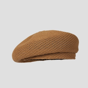 Detailed side view of a breathable camel summer knitted beret with mesh texture