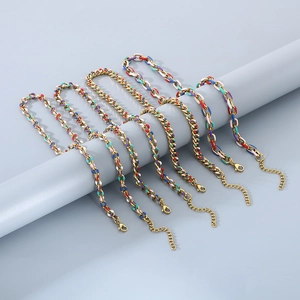 Detail of colorful enamel Cuban link bracelets in gold-plated stainless steel finish