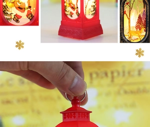 Close-up of Christmas lantern showing Santa Claus patterns and metal hanging rings