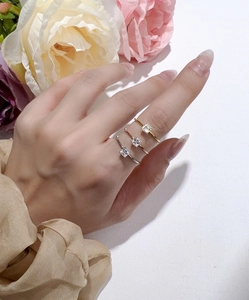 Three colors of Asscher cut moissanite rings shown on fingers in silver and gold