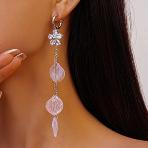 Close-up of long tassel earring featuring pink translucent petals and crystal flower