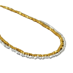 Minimalist irregular gold and silver faceted bead necklace for women on white background