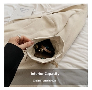 Internal capacity of pearl woven bucket bag showing phone and cosmetics inside
