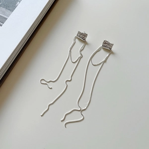 Detailed view of 925 sterling silver tassel earrings with irregular hammered texture