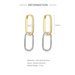 Detail of interlocking silver and gold wave earrings with dimensions 14mm by 8mm