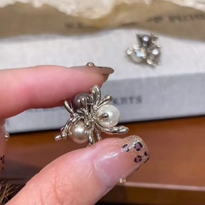 Silver spider earrings with white and grey pearls in a vintage handcrafted design