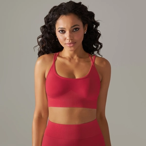 Close-up of red seamless sports bra and high-waist yoga leggings with ribbed texture