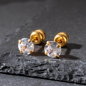 Macro shot of 5mm gold stainless steel stud earrings featuring sparkling round cubic zirconia