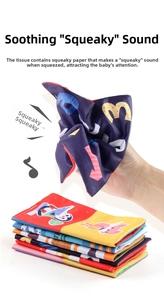 Detail of baby tissue box toy with crinkle paper fabrics featuring animal prints