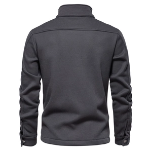 Detail view of the waffle texture and ribbed hem on charcoal grey men's jacket