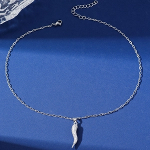 Silver horn pendant necklace with white diamonds on navy blue textured background