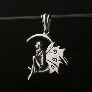 Macro detail of silver moon elf fairy pendant with wings made of stainless steel