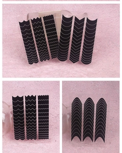 Detail of black heart and butterfly nail art stickers with various wave and V-shape patterns