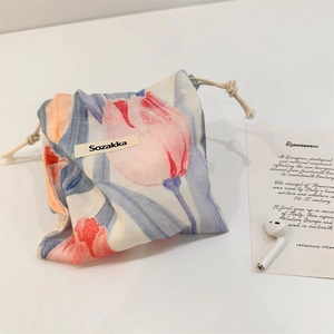 Close-up of fabric drawstring pouch with pink tulip pattern and cotton rope closure
