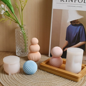Silicone sphere molds for DIY candles showing striped and spiral geometric textures