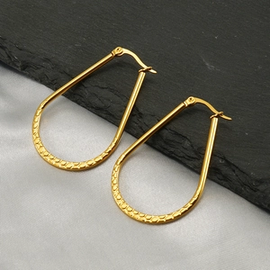 Textured gold oval earrings with a honeycomb pattern and secure snap-back closure