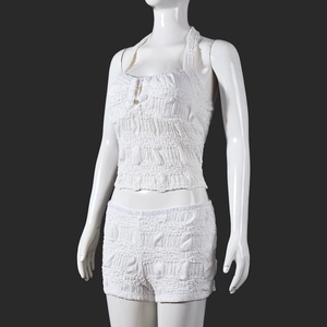 Detail of white textured bubble fabric on a sexy halter top and shorts set