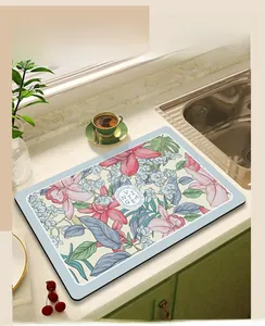 Absorbent kitchen mat with floral pattern on marble countertop for drying dishes