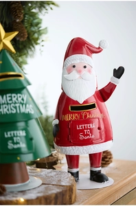 Close-up of red and green metal Christmas mailboxes with Santa Claus and tree details