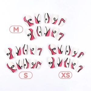 Abstract wave press-on nails in pink and black patterns with XS S M size labels