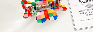 Top view of a colorful checkered floral hair claw clip made of acrylic with metal spring
