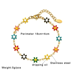 Detail of colorful dripping oil flower charms on golden stainless steel bracelet