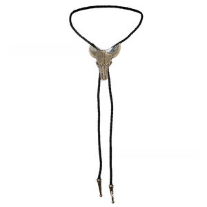 Close-up of vintage bronze bull skull pendant on black braided leather bolo tie