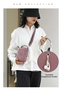 Detail of purple nylon crossbody bag featuring a convenient built-in headphone port