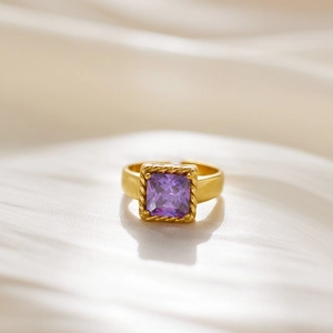 Detail of square purple zircon ring with vintage twisted gold edge and four-prong setting