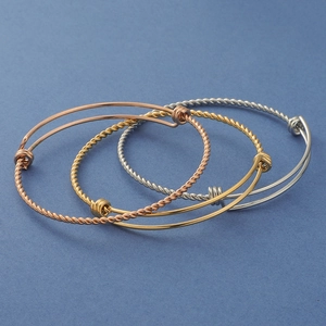 Three-piece twisted wire adjustable bangle set in rose gold, gold, and silver finishes