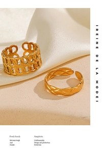 Close-up of gold plated stainless steel chain ring and quilted texture band on stone