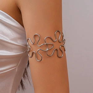 Silver hollow flower petal arm cuff in wavy metal design worn on female upper arm