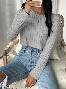 Slim fit light gray ribbed knit crop top paired with distressed denim jeans for casual wear