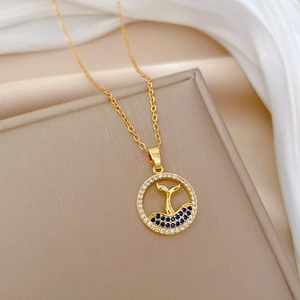 Gold titanium necklace with sparkling fishtail pendant and blue gemstones on silk