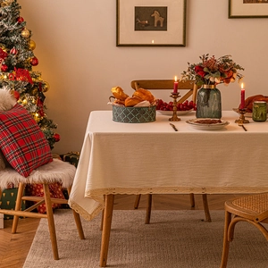 Beige rectangular tablecloth with lace edges in a cozy Christmas dining room setting