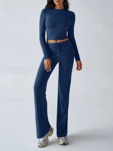 Detail view of navy blue yoga set with long sleeve crop top and drawstring pants