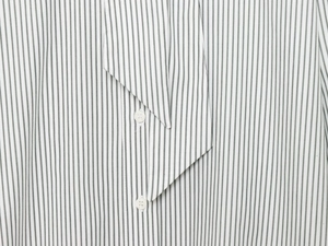 Detail of striped poplin shirt with white buttons and elegant neck tie scarf