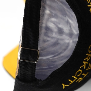 Detail of adjustable metal buckle strap and embroidery on distressed baseball cap
