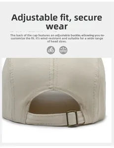 Close-up of beige canvas baseball cap with adjustable metal buckle at the back